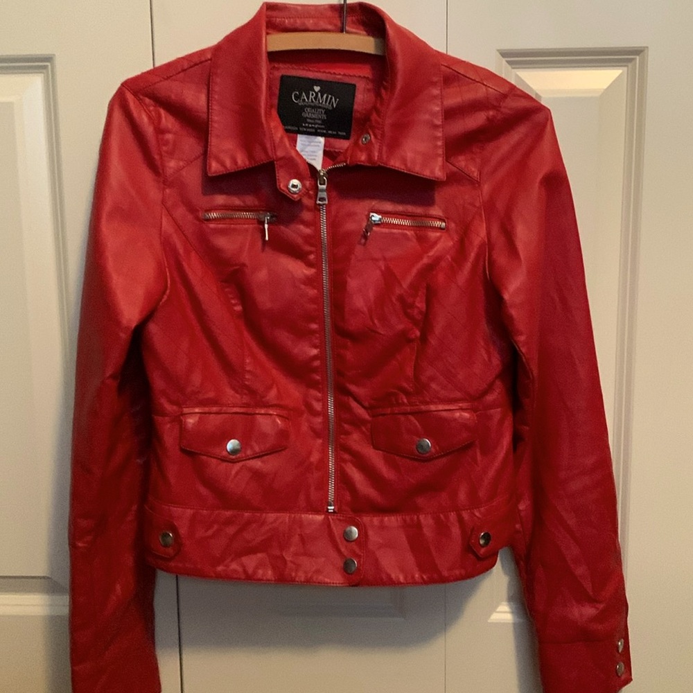 Jacket with metal snaps on pockets and cuffs. The zipper pockets say Bad A$$!